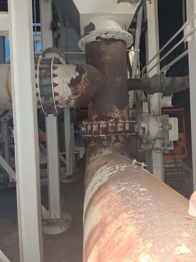 Corroded ductwork and pipe junction before blasting and heat resistant coating