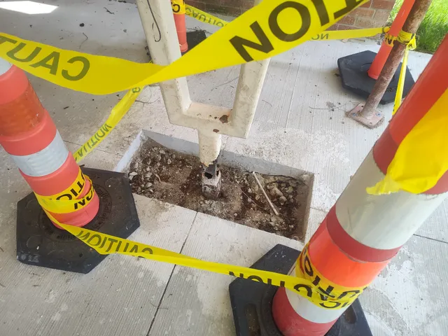 Excavated post anchor revealing heavy internal corrosion