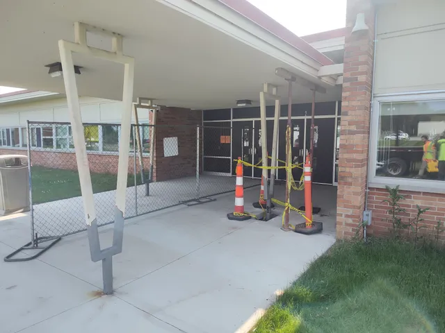 Wide shot of school entrance awning remediation