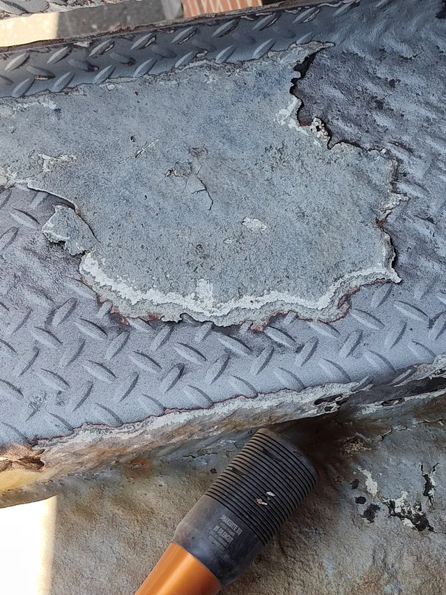 Close-up of deteriorating diamond plate