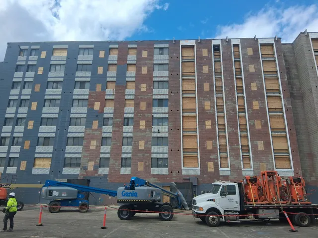 Concord Tower Apartments — mobile blast rig and boom lift at the high-rise